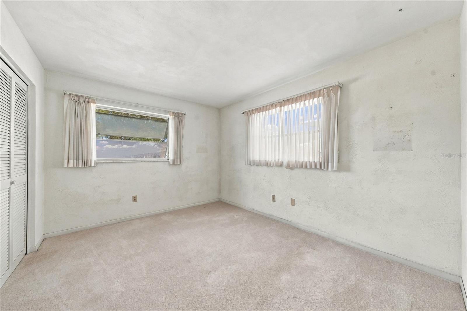 Large windows featuring ample natural light in primary bedroom