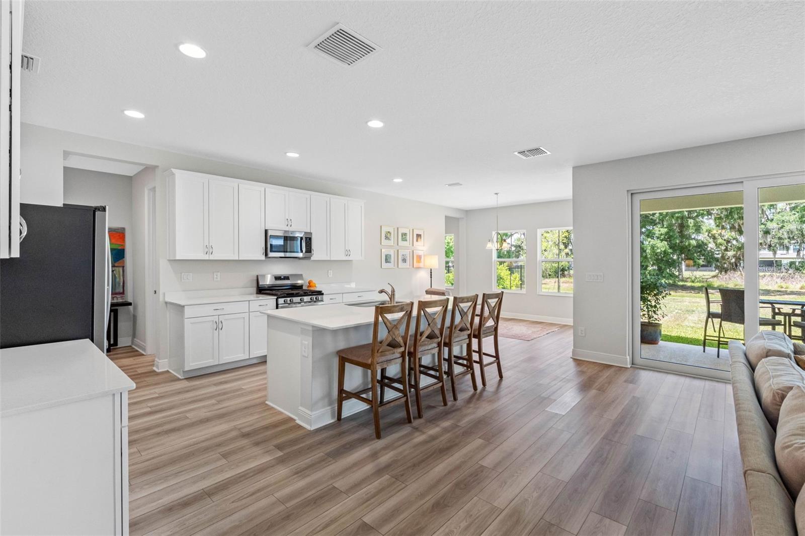 Bright kitchen and cafe with tree-lined backyard views Bright kitchen and cafe with tree-lined backyard views