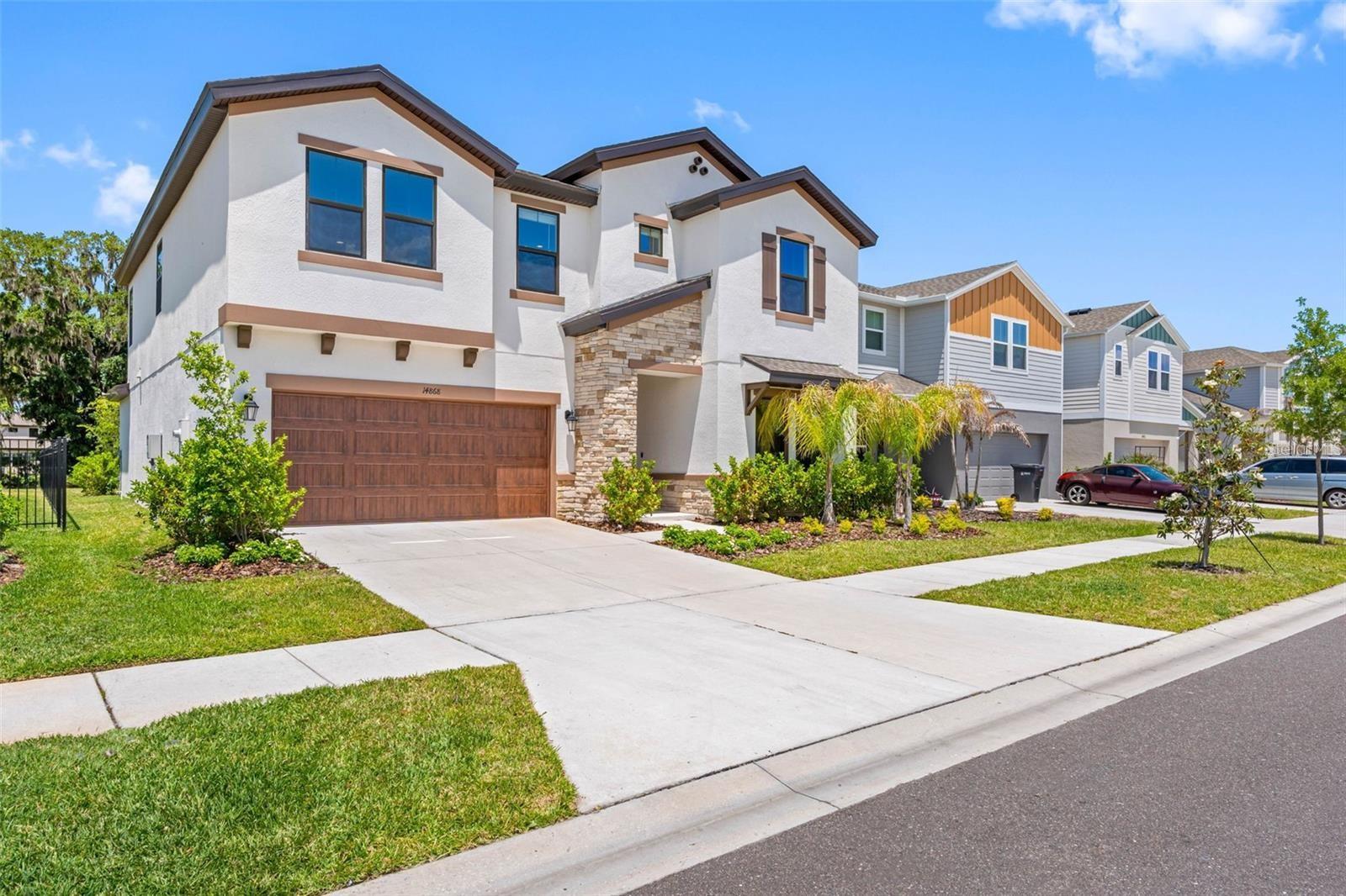 Landscaped front yard with sidewalks in Hinton at Hawkstone