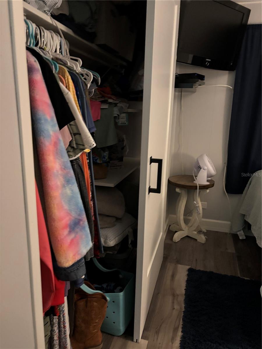 Primary bedroom walk in closet