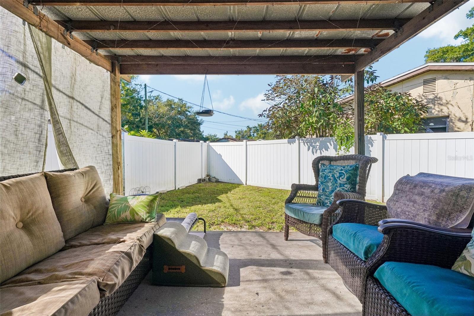 Unit 1 covered outdoor area- white vinyl fence for privacy