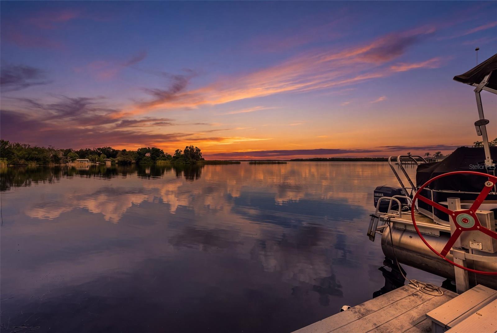 This is why people fall in love with waterfront living! Enjoy expansive water views, beautiful sunrise reflections, and the convenience of a private dock. Whether you're heading out on the boat or simply enjoying the evening, the waterfront lifestyle takes center stage.