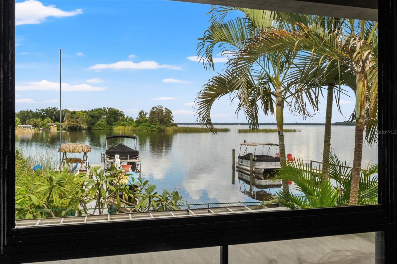 This is what Florida waterfront living is all about! Enjoy sweeping water views framed by tropical palms, with private docks and boats just beyond the backyard. A beautiful setting for morning coffee, watching wildlife, or simply appreciating the scenery.