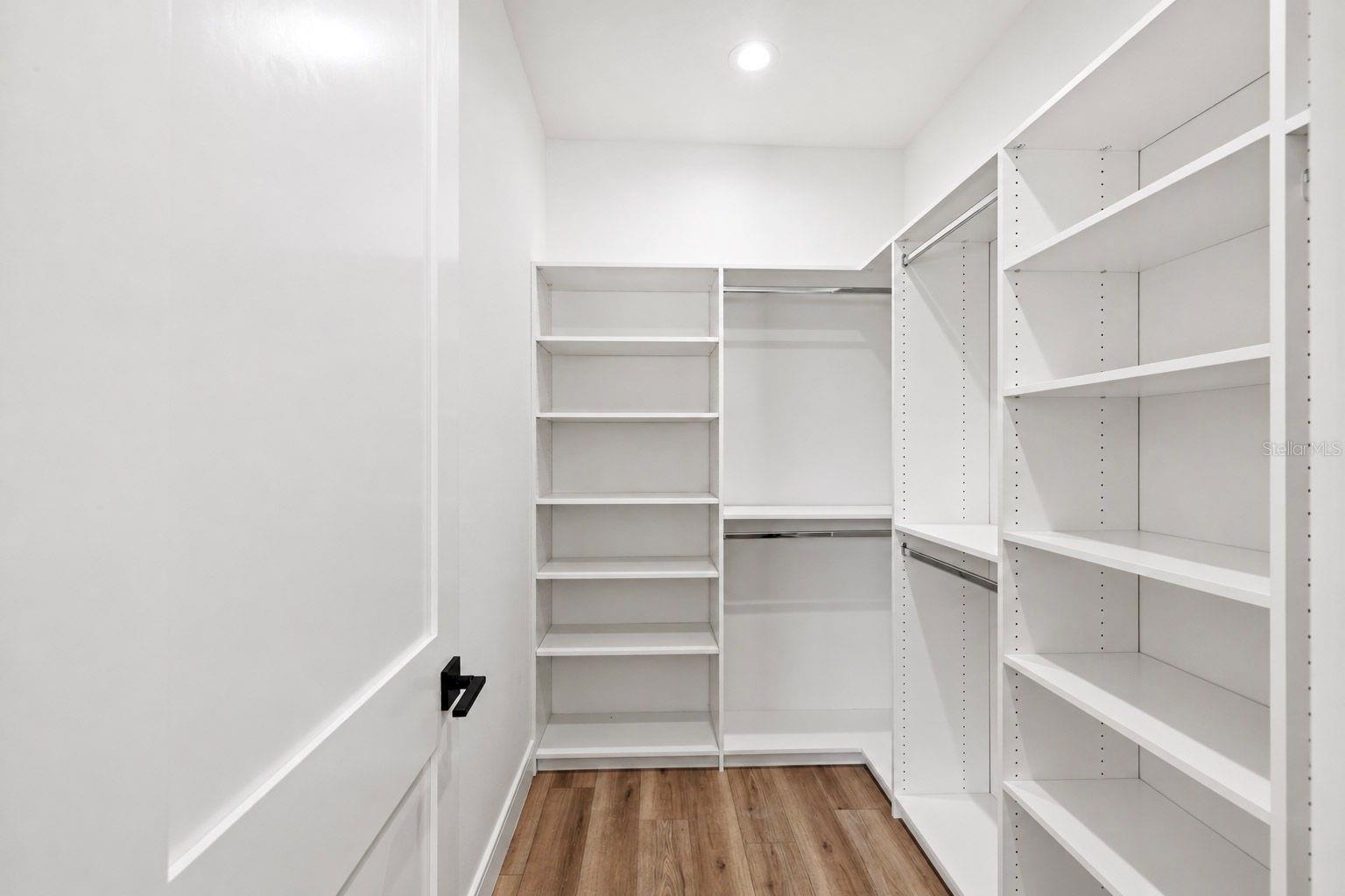 Primary bedroom walk-in closet