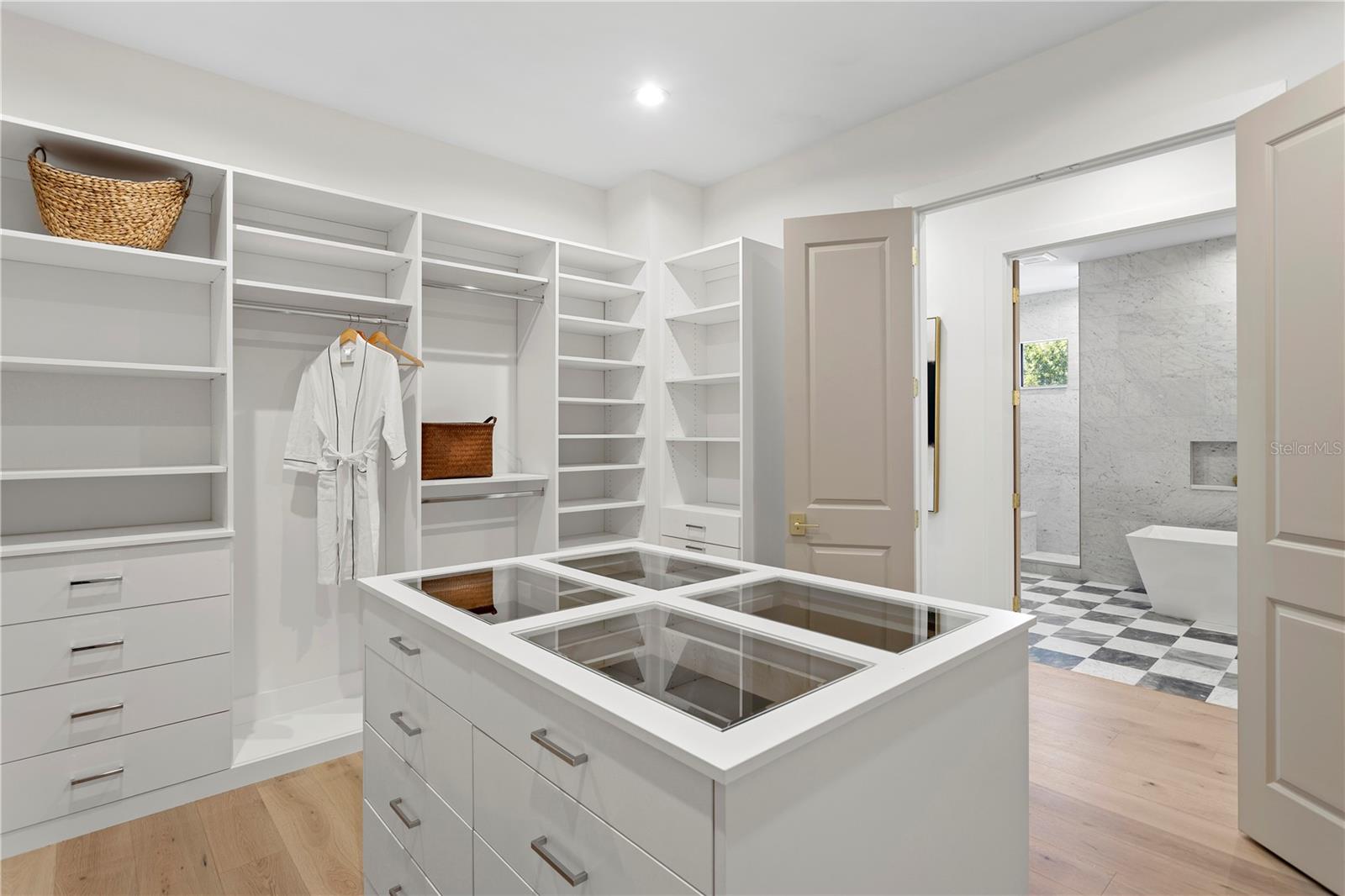 Primary walk in closet with center island