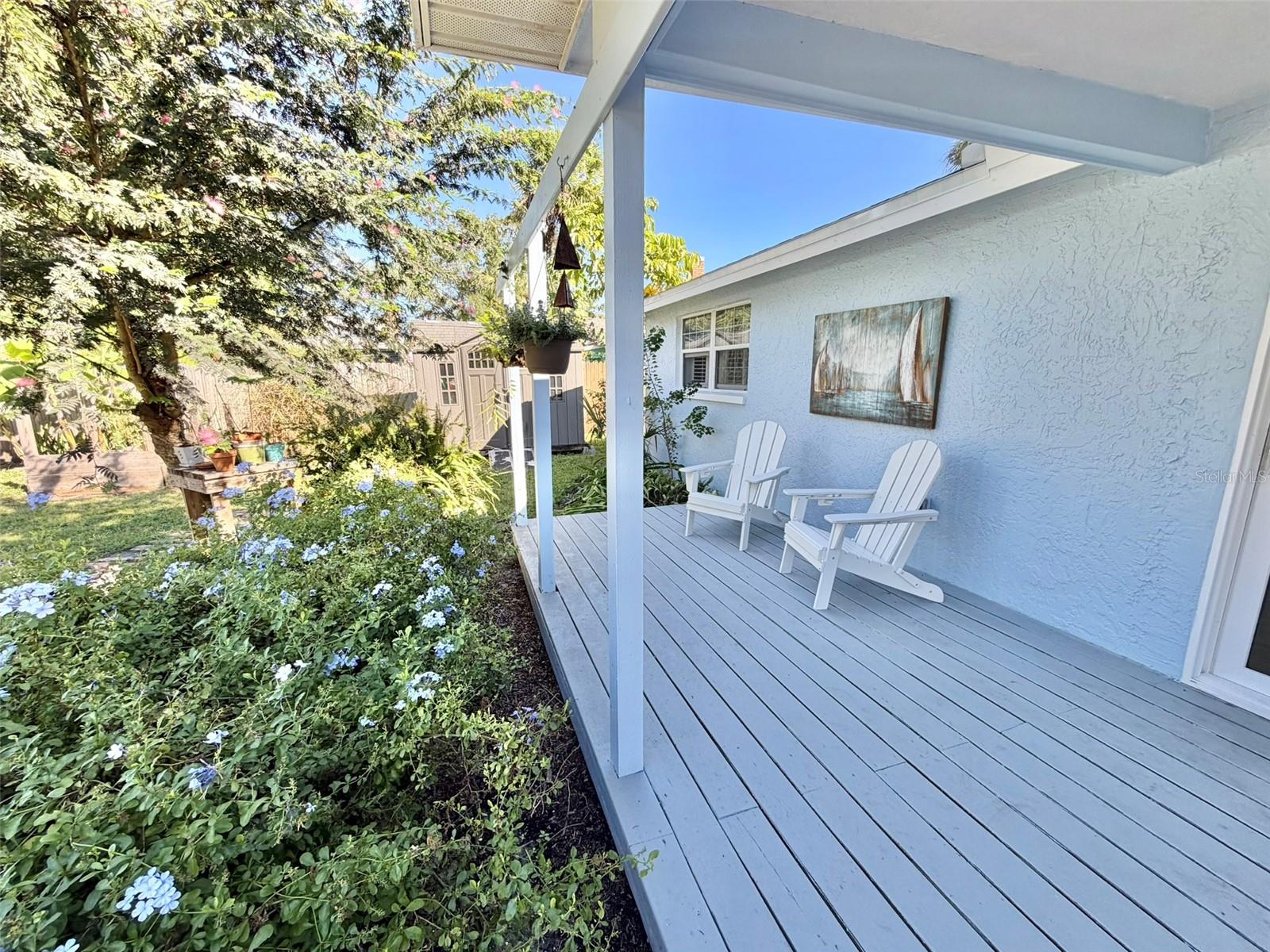 A Large Deck in the back yard is partially covered for all weather enjoyment.
