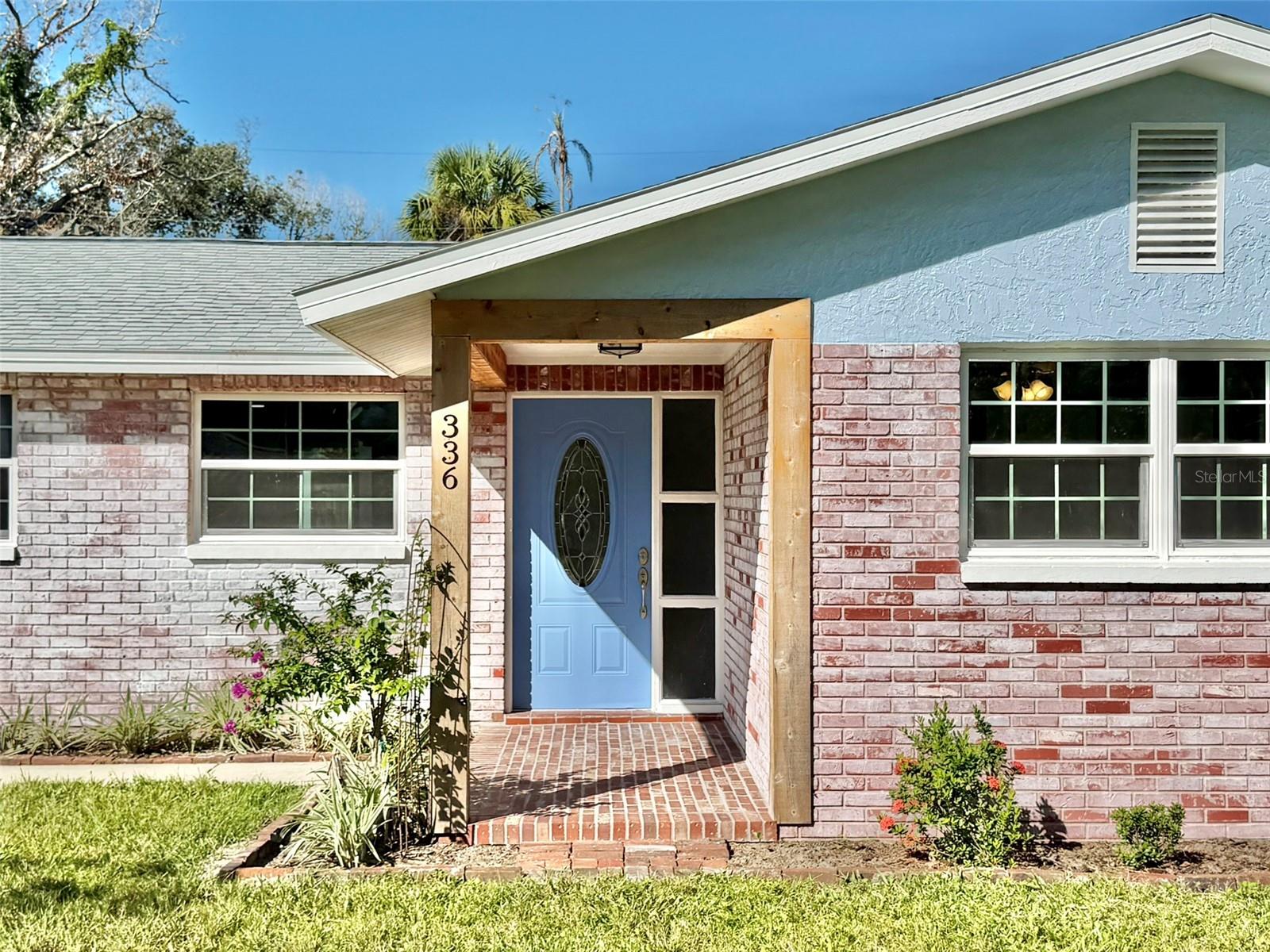 Warm Cedar Accents Surround the Covered Front Porch