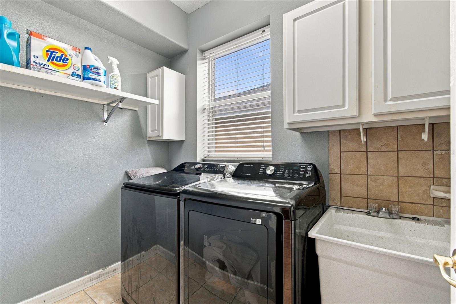 Your laundry room is bright and cheerful with a window and laundry sink.