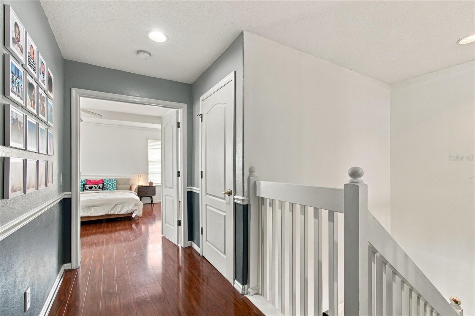 Private hallway leading to a double door entry for the primary suite.