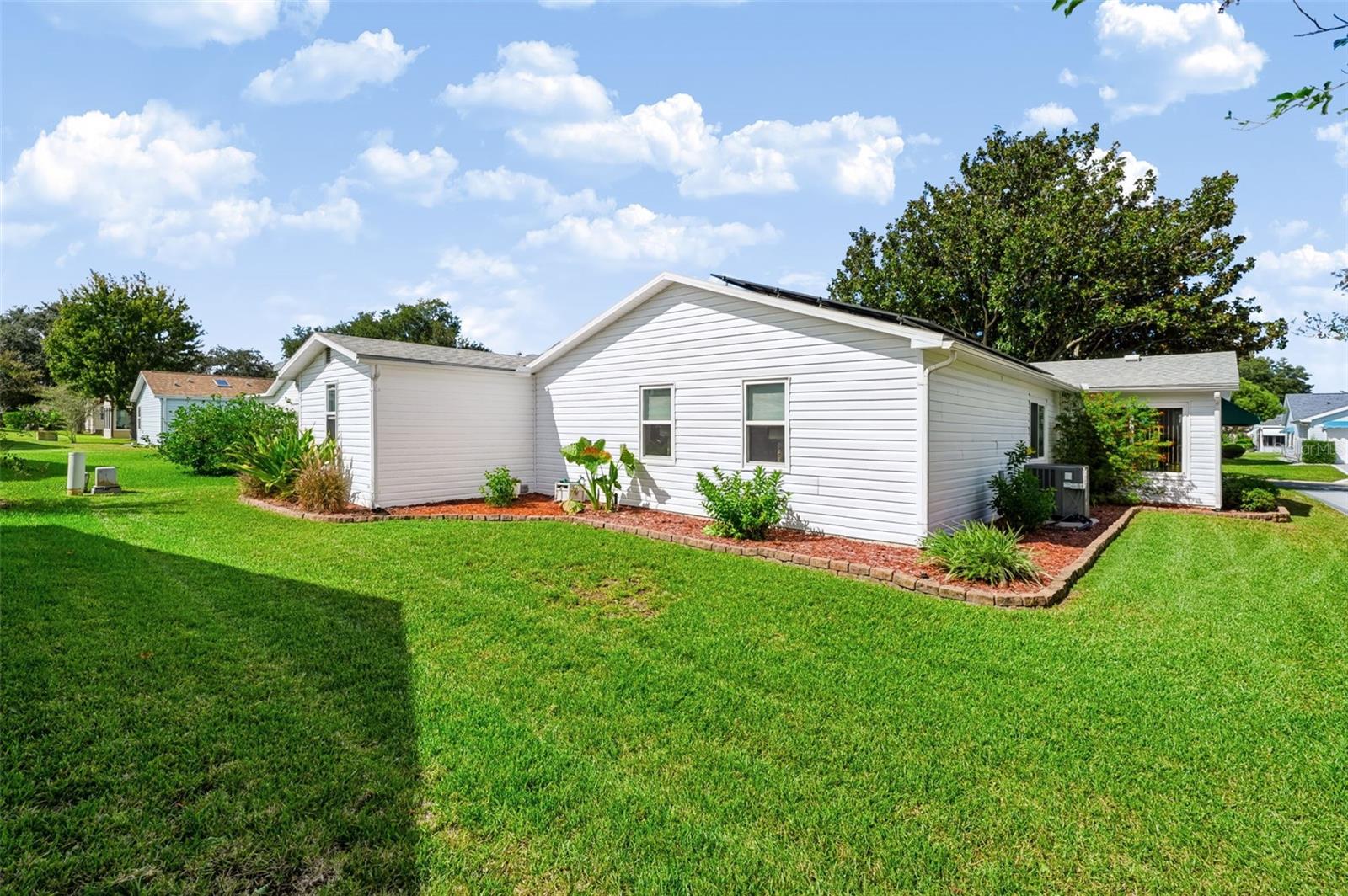 Backside of home with landscaping