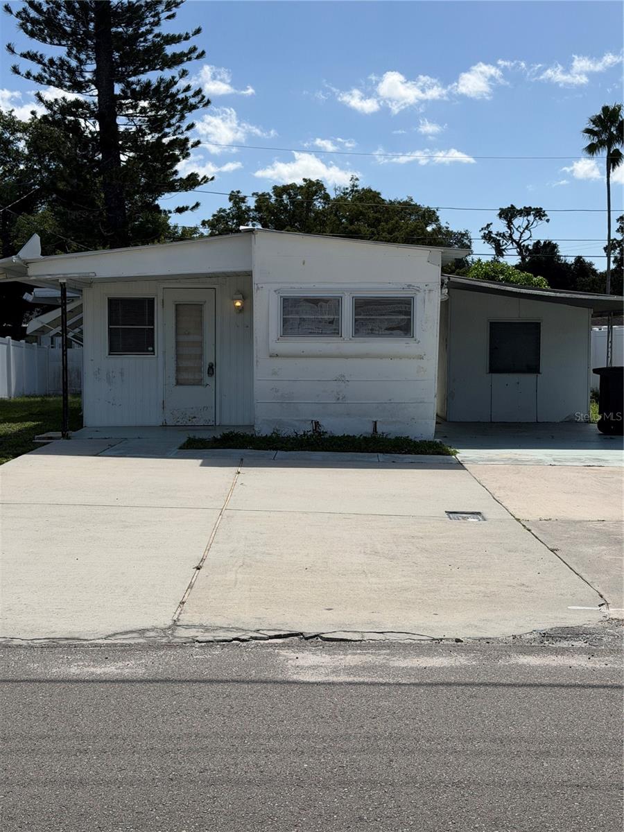 Mobile home with added on sides, carport and large parking pad. Mobile home with added on sides, carport and large parking pad.