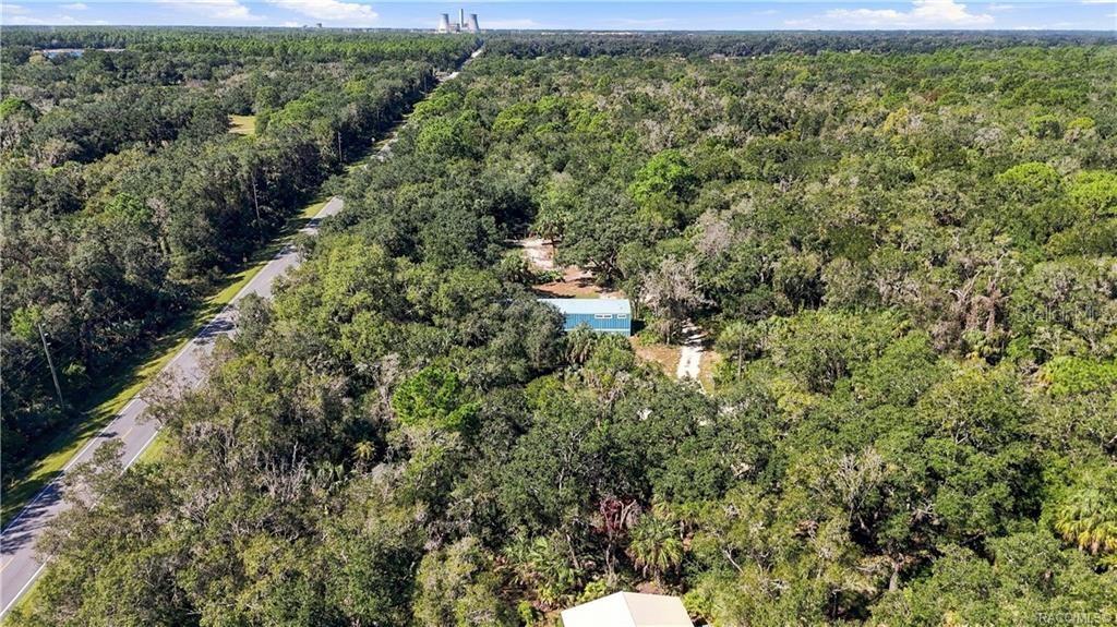 SURROUNDED BY NATURE! This expansive aerial view captures the home tucked among beautiful trees & the wooded character of the surrounding area.