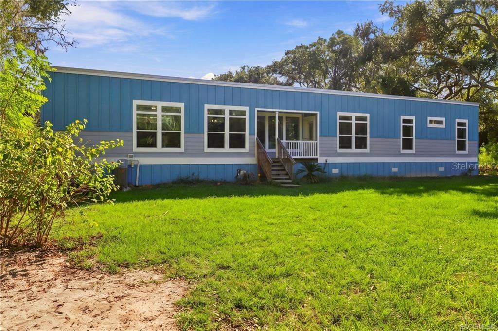 SPACE TO ENJOY THE OUTDOORS! The spacious lawn, mature shade trees & inviting covered front porch create a wonderful setting for enjoying the peaceful surroundings.