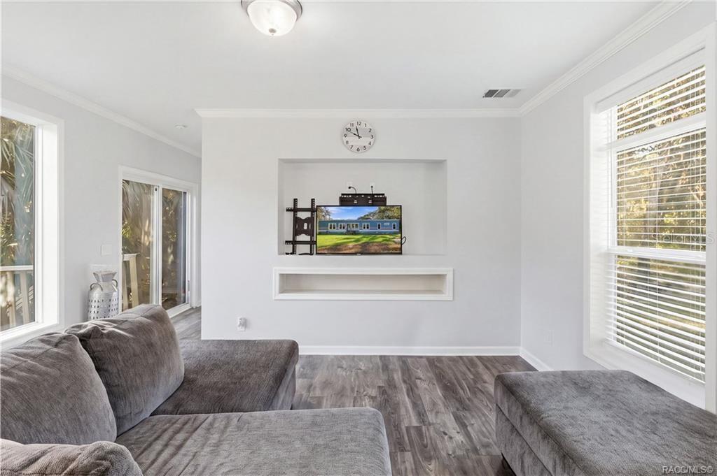 A COZY PLACE TO UNWIND! Enjoy the comfortable living area featuring large windows, neutral finishes & a recessed entertainment space.