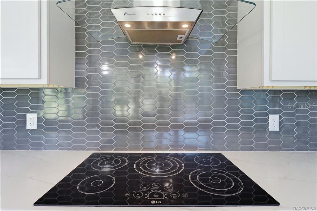 PLENTY OF ROOM TO COOK & CREATE! Enjoy extensive GRAY CABINETRY, stainless steel appliances, an LG SMART OVEN, CONVECTION MICROWAVE & spacious center island.
