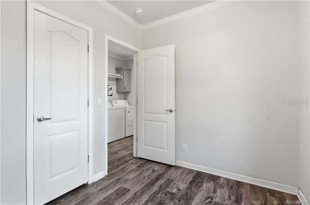 FLEXIBILITY FOR YOUR LIFESTYLE! Another view of this room highlights the attractive flooring, natural light & convenient access to the indoor laundry area.