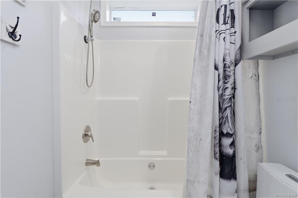 A LITTLE EXTRA COMFORT! The TUB/SHOWER COMBINATION offers a handheld showerhead, natural light from an upper window & a convenient bathing space.