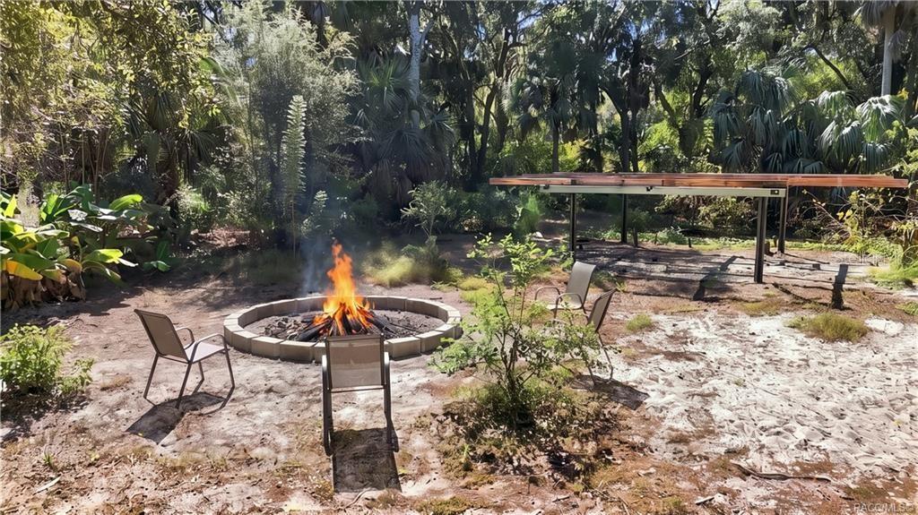 GATHER AROUND THE FIRE! A circular FIRE PIT AREA surrounded by seating offers an inviting spot for evening conversations, roasting marshmallows & enjoying the outdoors.