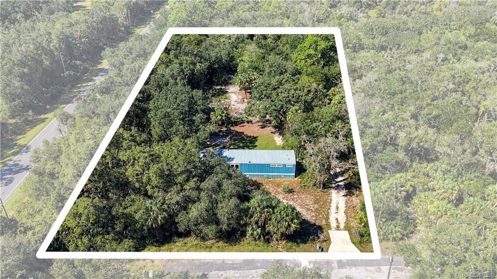 AERIAL PROPERTY VIEW: A beautiful look at the 1.42 FULLY FENCED ACRES w/GATED ENTRANCE, surrounded by mature trees, Florida palms & natural greenery. Room to enjoy the outdoors!