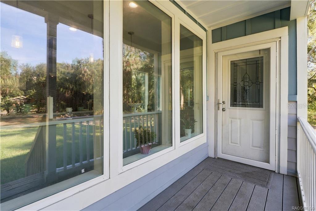 A WELCOMING FIRST IMPRESSION! The covered entry features attractive windows, white railings & a decorative glass front door that adds character.