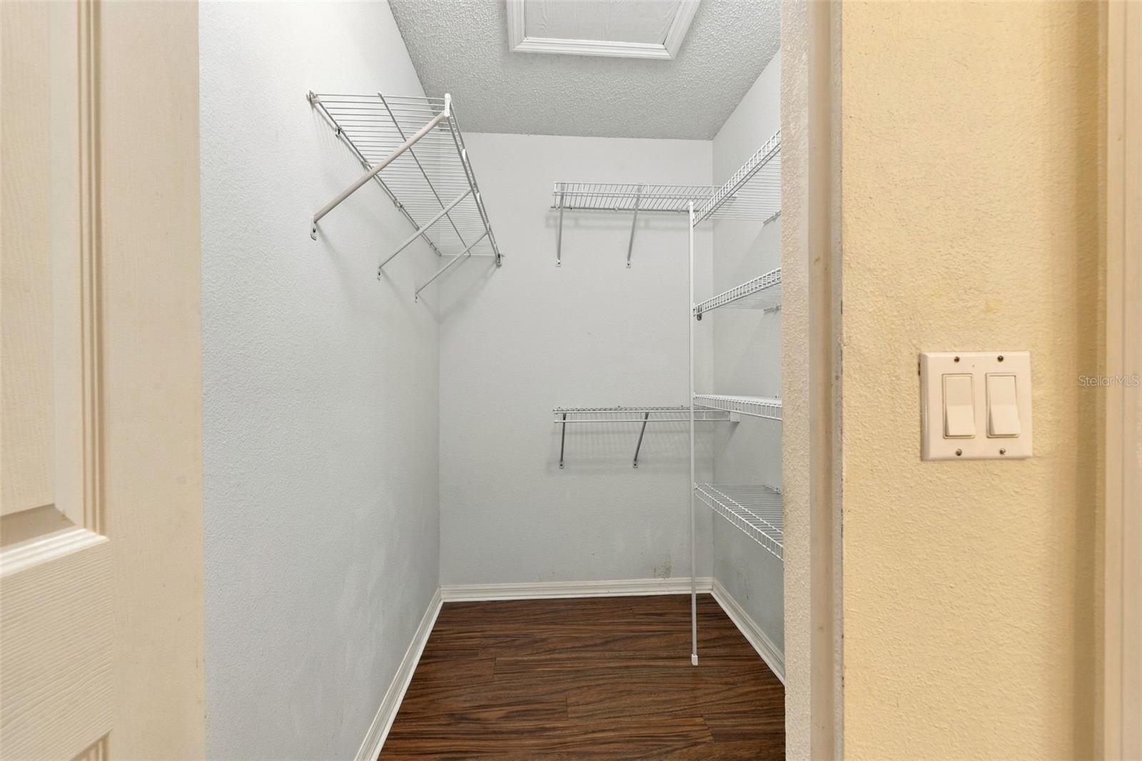 Primary bedroom walk-in closet