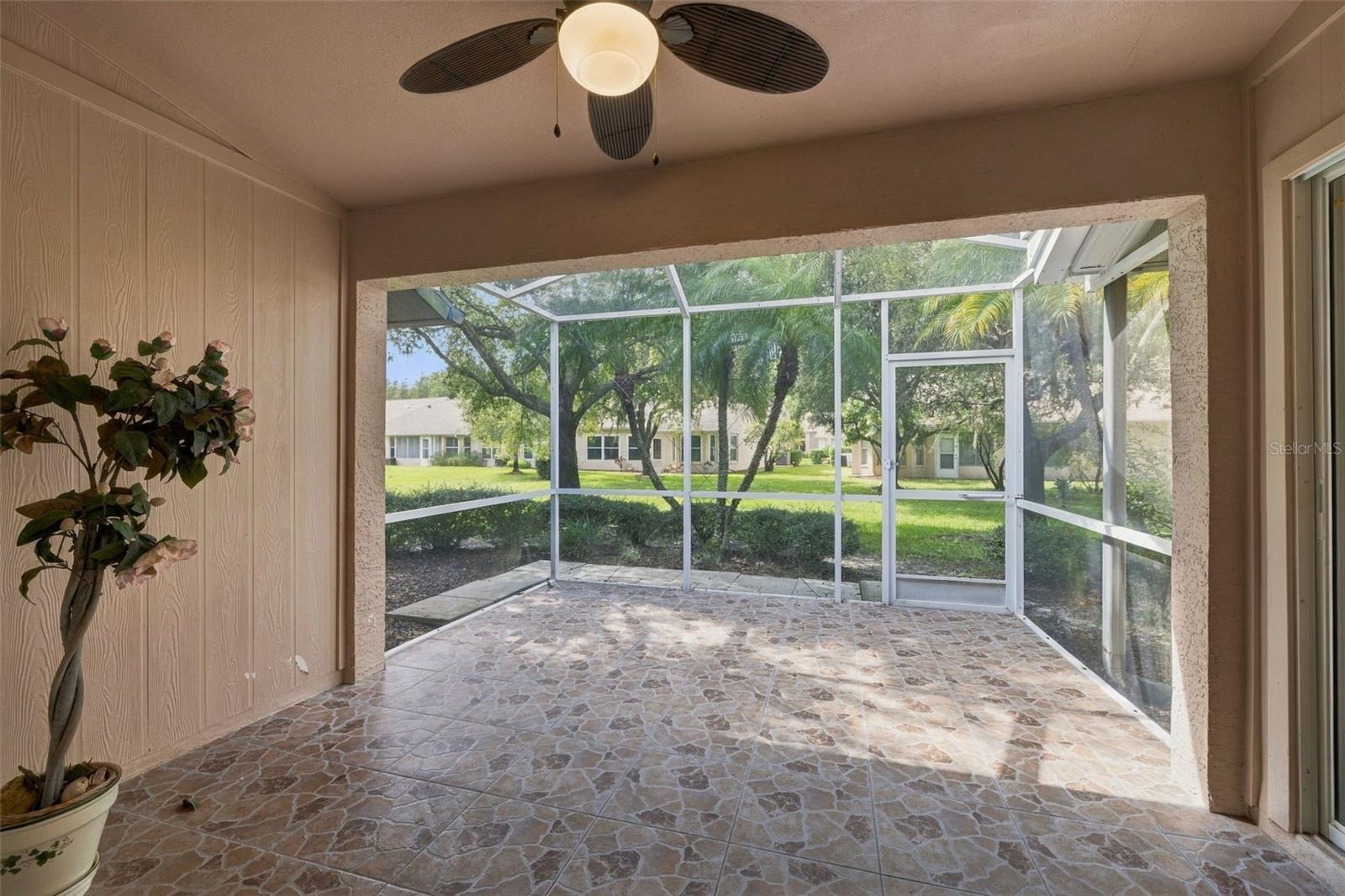 Tiled and screened-in lanai, accessed through the dining room or kitchen area