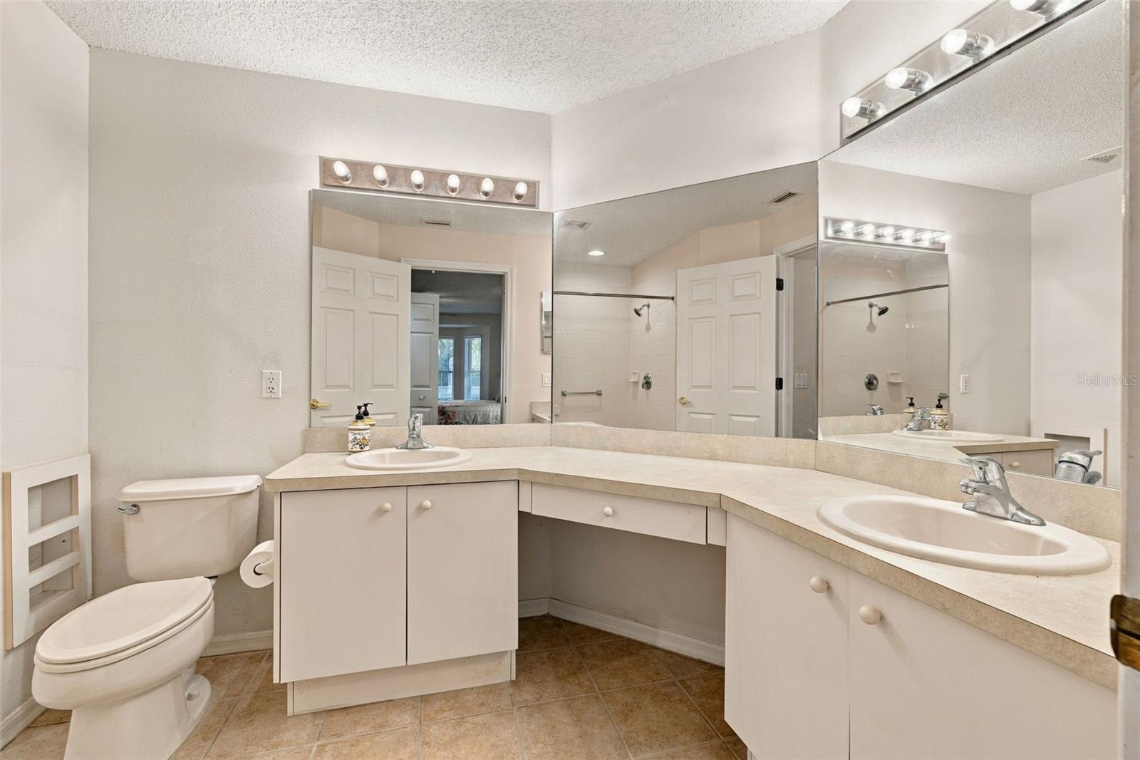 Primary en-suite bathroom with dual sinks