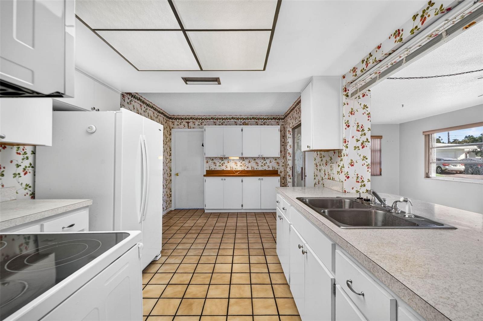 Huge kitchen with a convenient pass-through window that connects directly into the sunlit Florida room Huge kitchen with a convenient pass-through window that connects directly into the sunlit Florida room