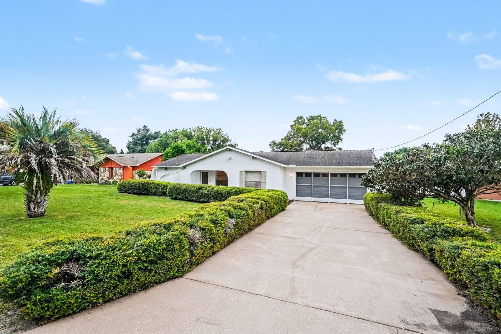 Wide Driveway Leads to Attached Two-Car Garage and Entry