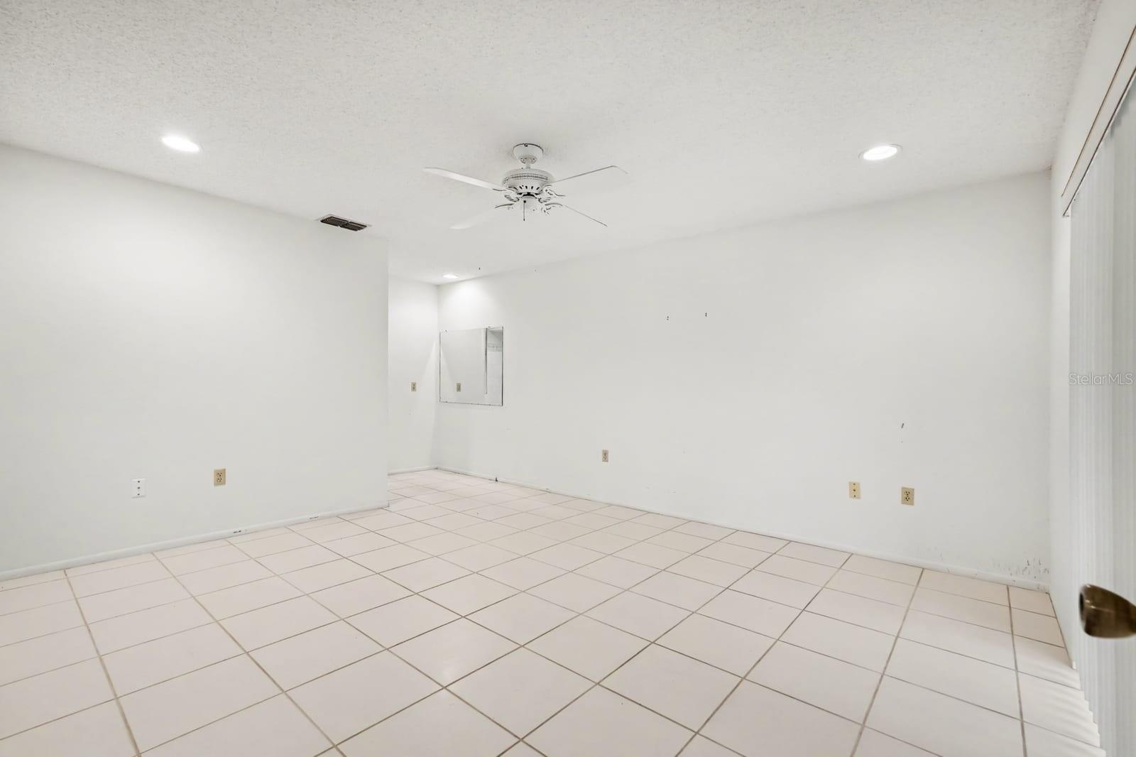 Spacious Secondary Bedroom with Tile Flooring and Multiple Electrical Outlets