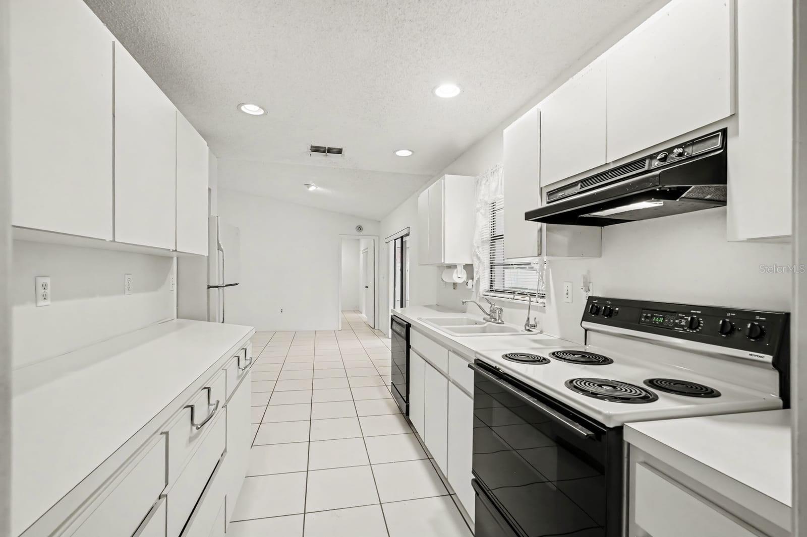 Kitchen Features Electric Range, Refrigerator & Abundant Counter Space