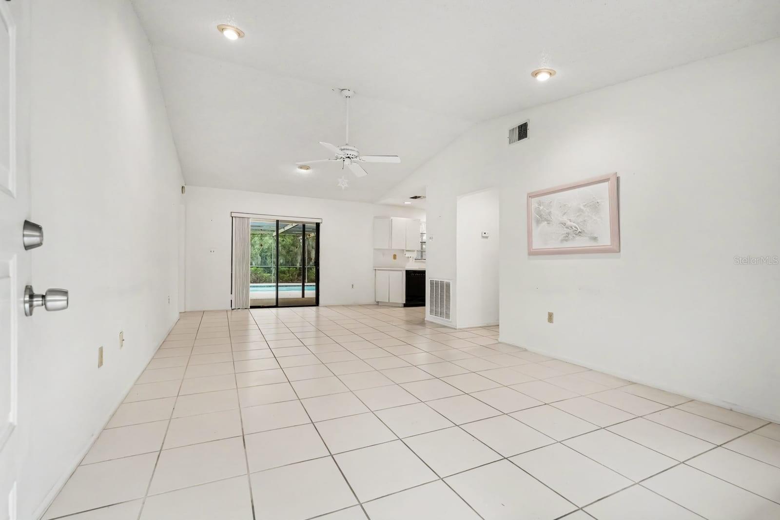 Bright Living Area with Sliding Glass Doors to Backyard and Ceiling Fan