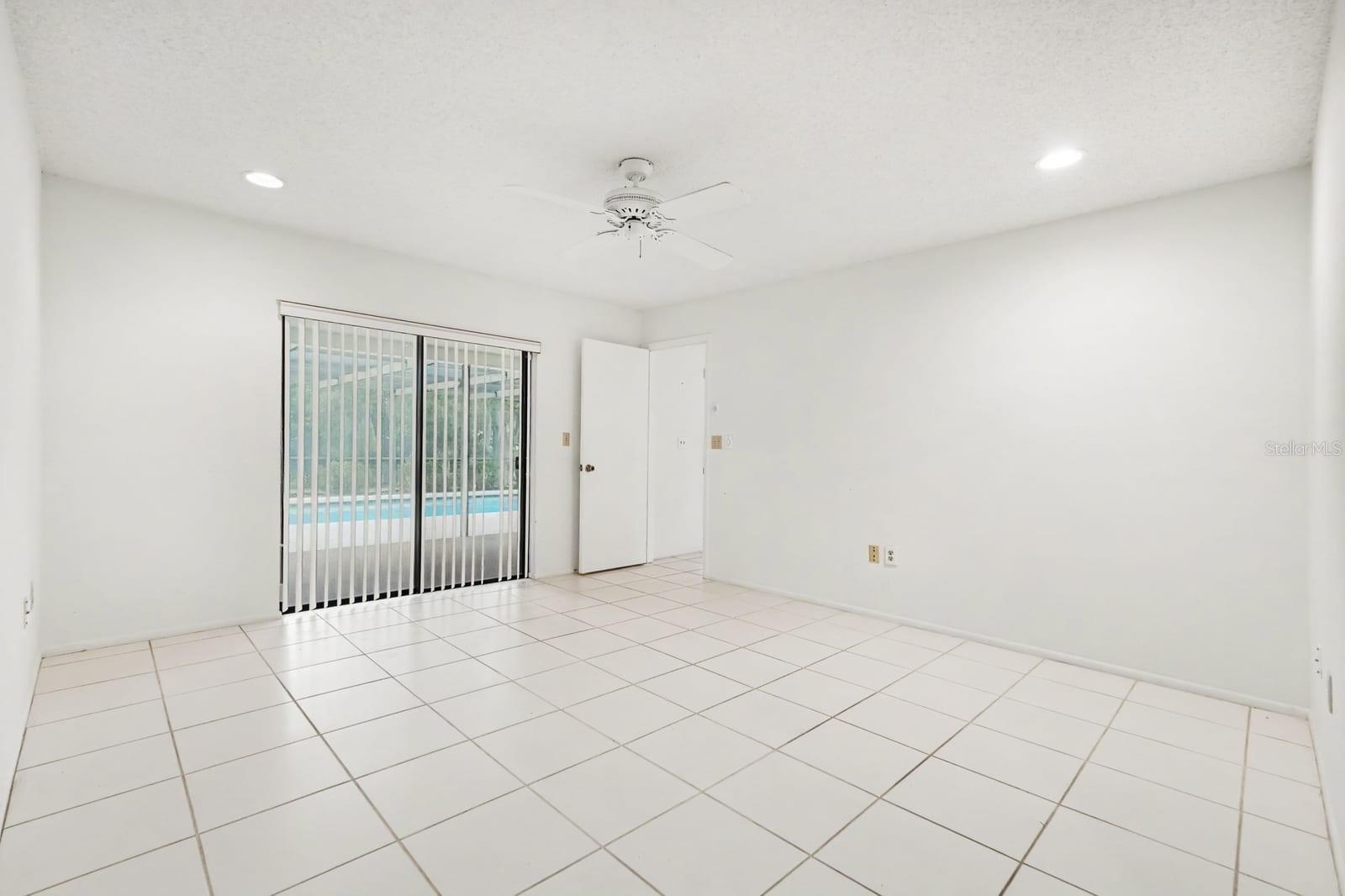 Spacious Room with Sliding Glass Doors to Pool and Patio Area