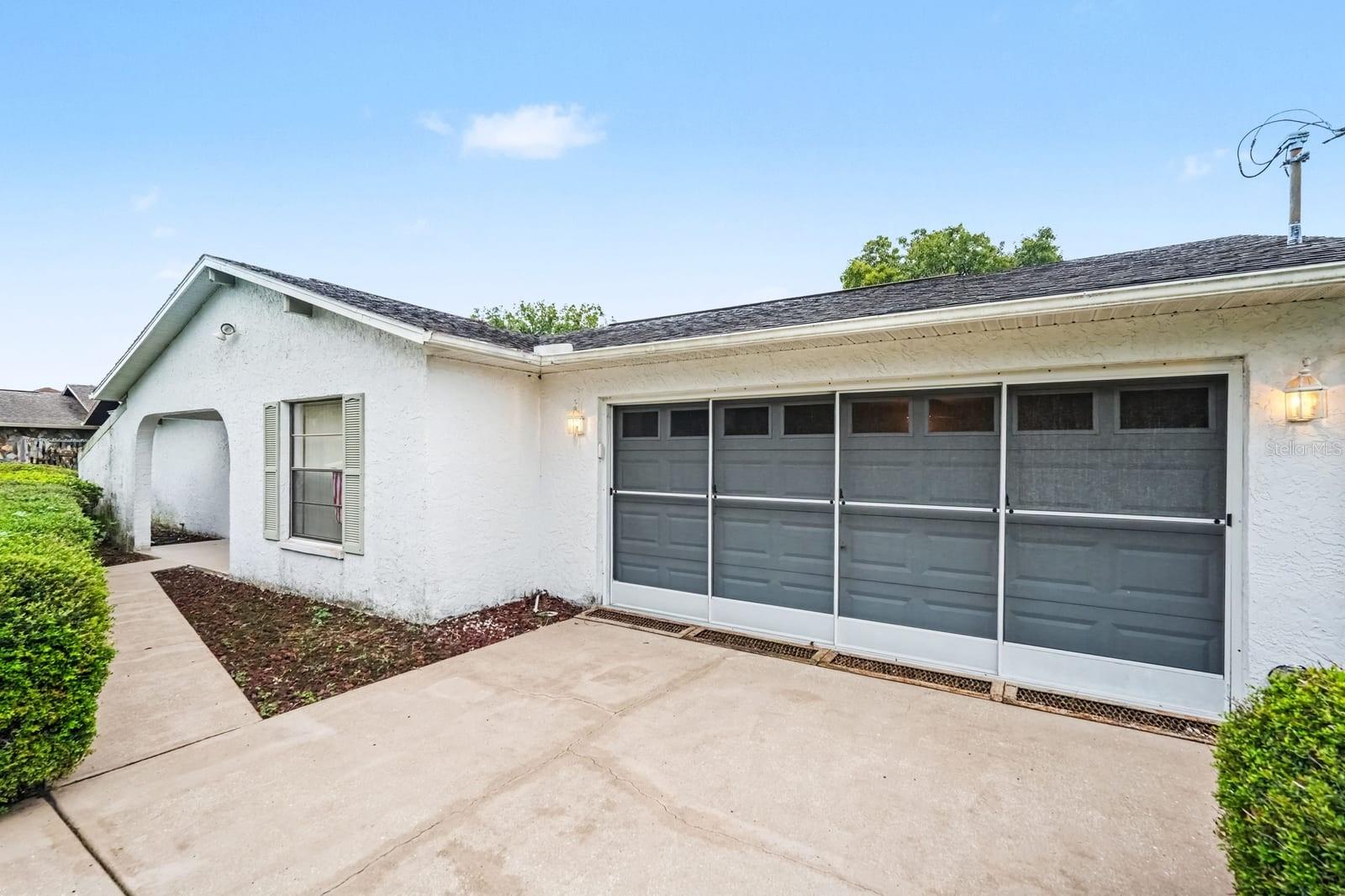 Two-Car Garage with Large Door Windows and Covered Entry