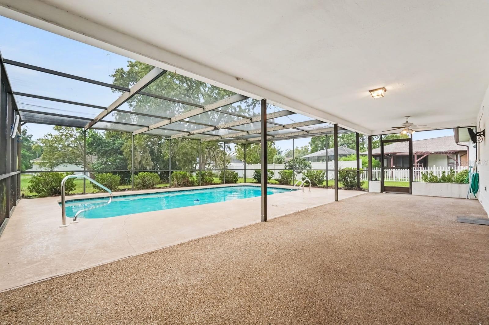 Covered Pool with Screened Enclosure, Clean Water, and Shade Structure