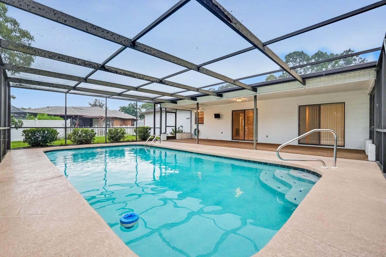 Resort-Style Screened Pool with Clear Water and Expansive Deck