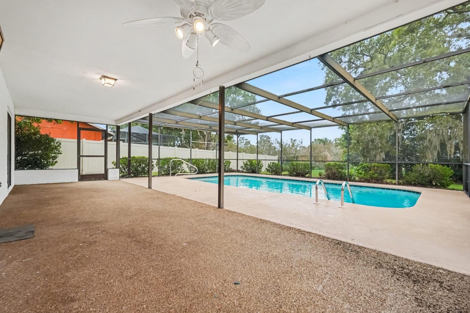 Spacious Screened Pool Area with Ceiling Fans and Lounge Access