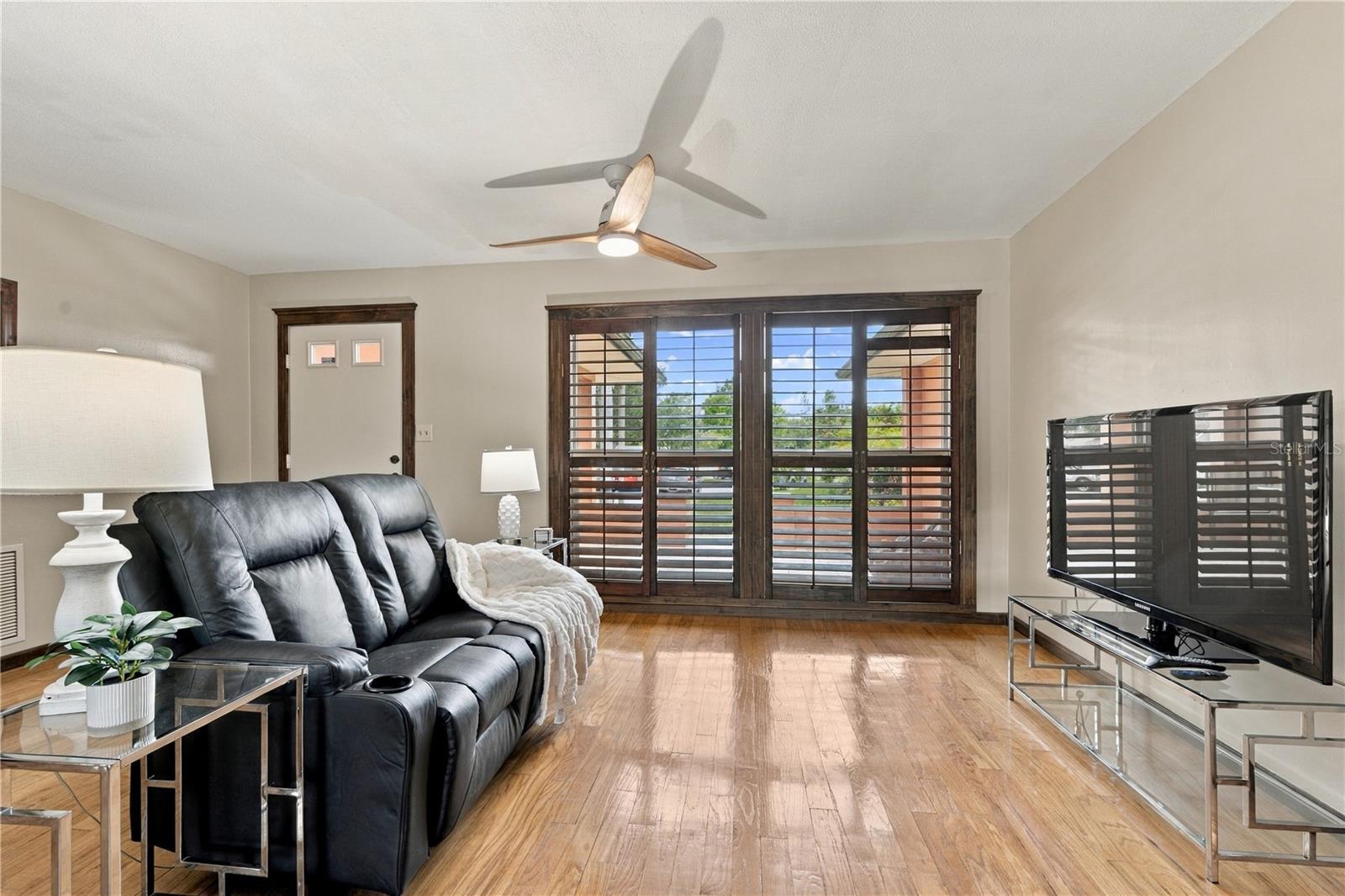 11. Front Living Room is (12.7 x 15') .. with Wood Shutters for a Touch of Elegance!