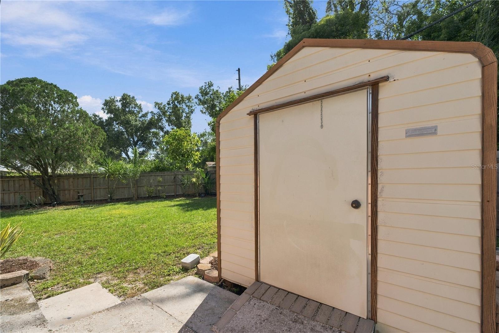 73. Elevated Metal Shed on Concrete Pad with Extended Slab for Ease of Use!