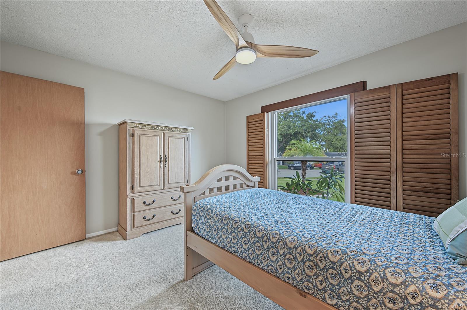 28. Bedrm #3 (11 x 12.9') Features Wood Shutters that Open Out to the Wall if Desired, or Adjust the Slats..
