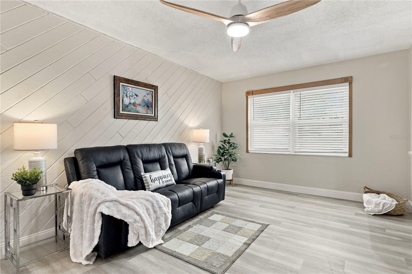 55. Family Room (18.9 x 10.10') with Awesome Wood Accent Wall, Slats Running Diagonally - Creating Visual Interest!!