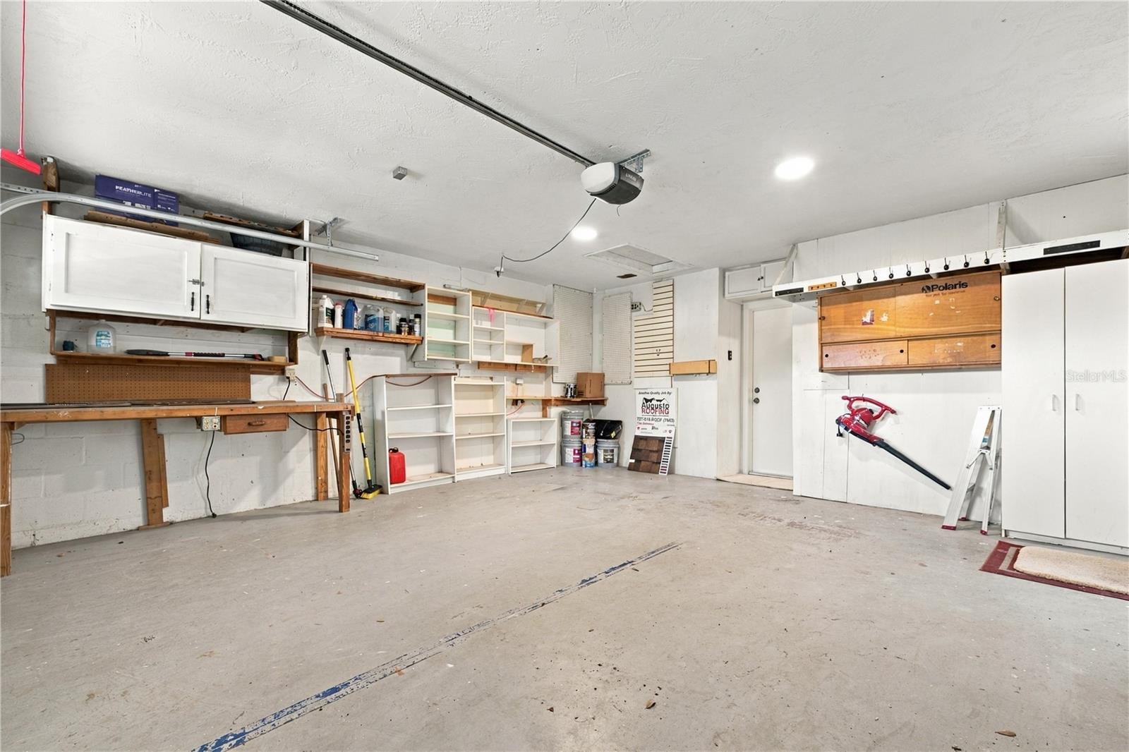 68a. Garage with FRESHLY Painted Ceiling! Plenty of Storage.. 3 of the Bookshelves Shown in Picture Have Been Removed.. Existing Storage is Sturdy & Ready for Your Storage Needs!