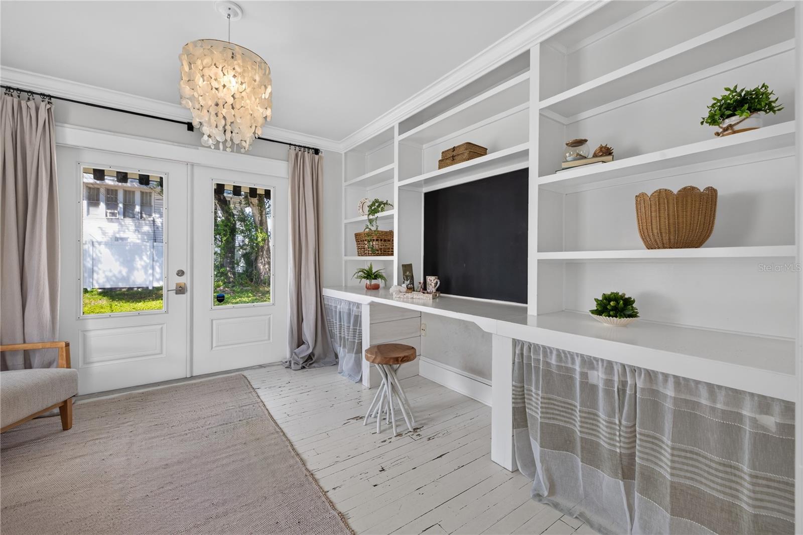 Built ins in the flex bedroom / office with doors to backyard