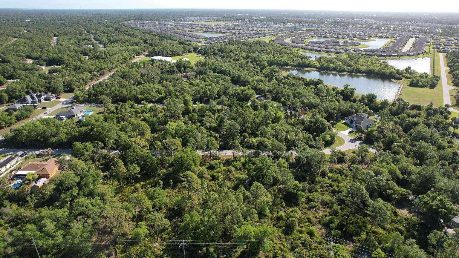 Aerial view of the surrounding area; nearby water features are not part of this property and do not establish access rights.
