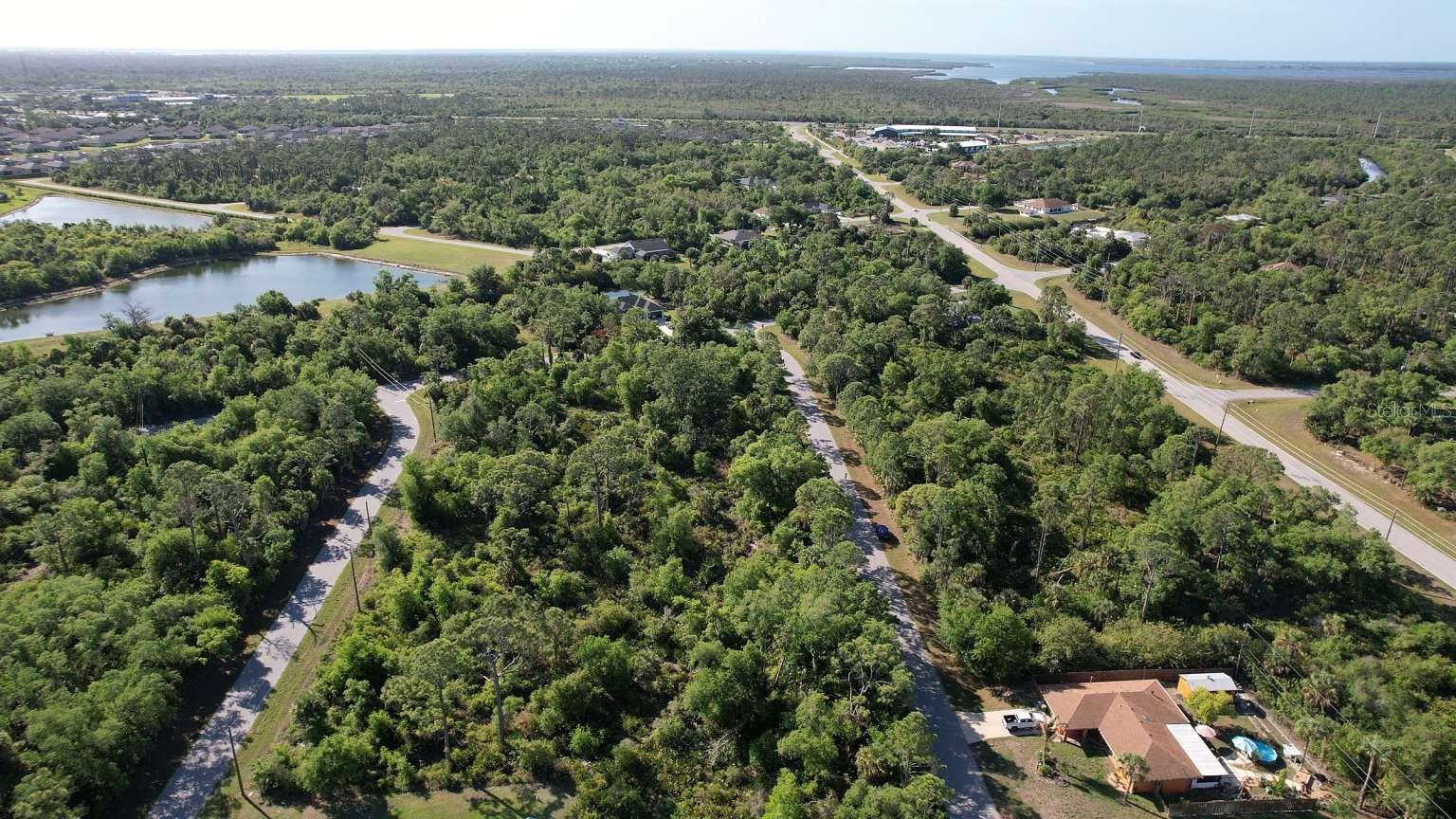 Aerial view of the surrounding area; nearby water features are not part of this property and do not establish access rights.