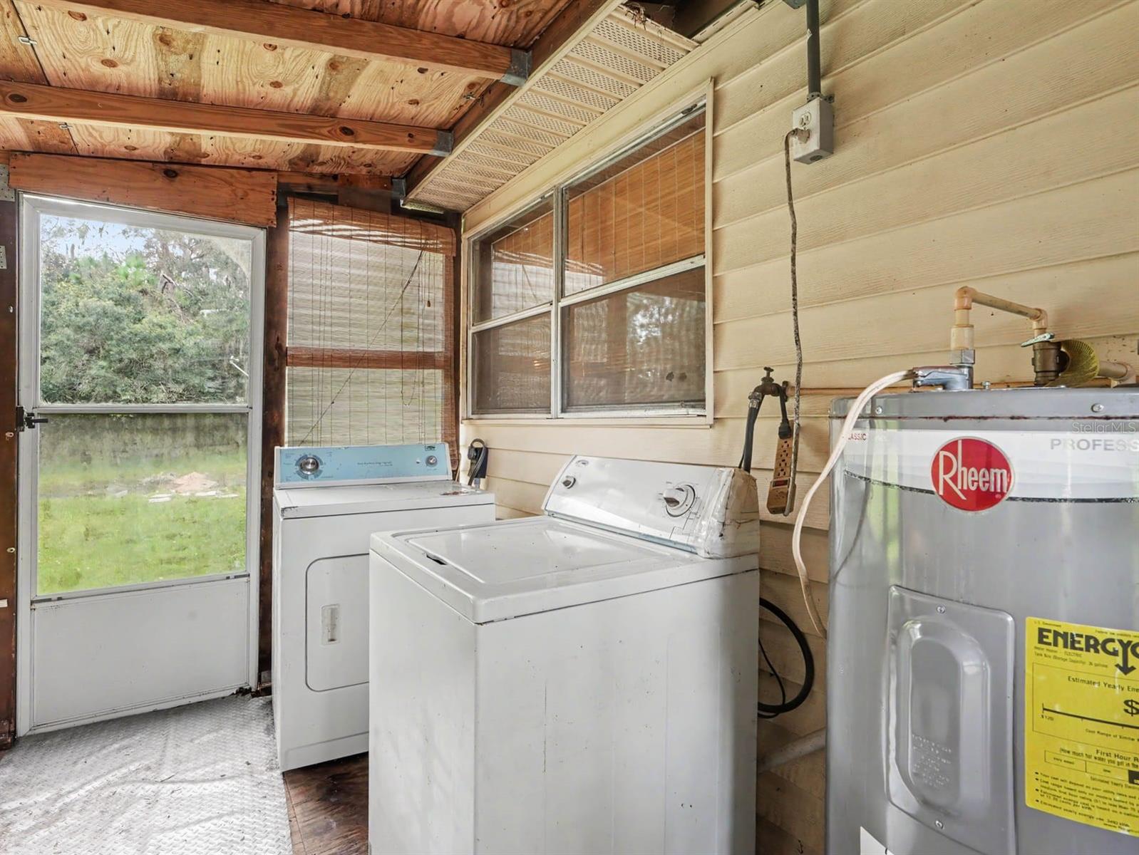 Laundry Room with Washer, Dryer & Water Heater Access to Yard