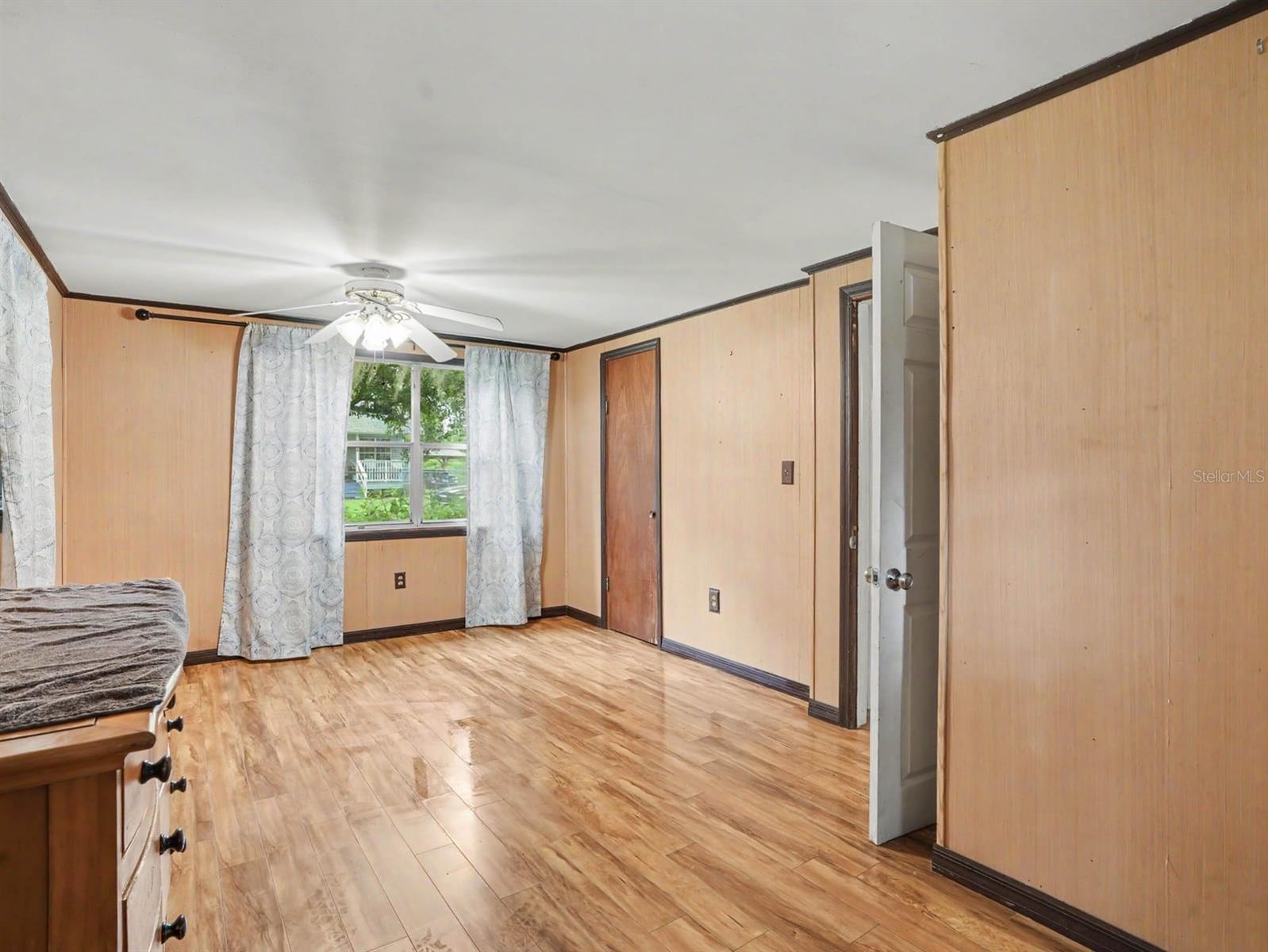Comfortable Bedroom with Wood Floors, Window Seat & Direct Patio Access