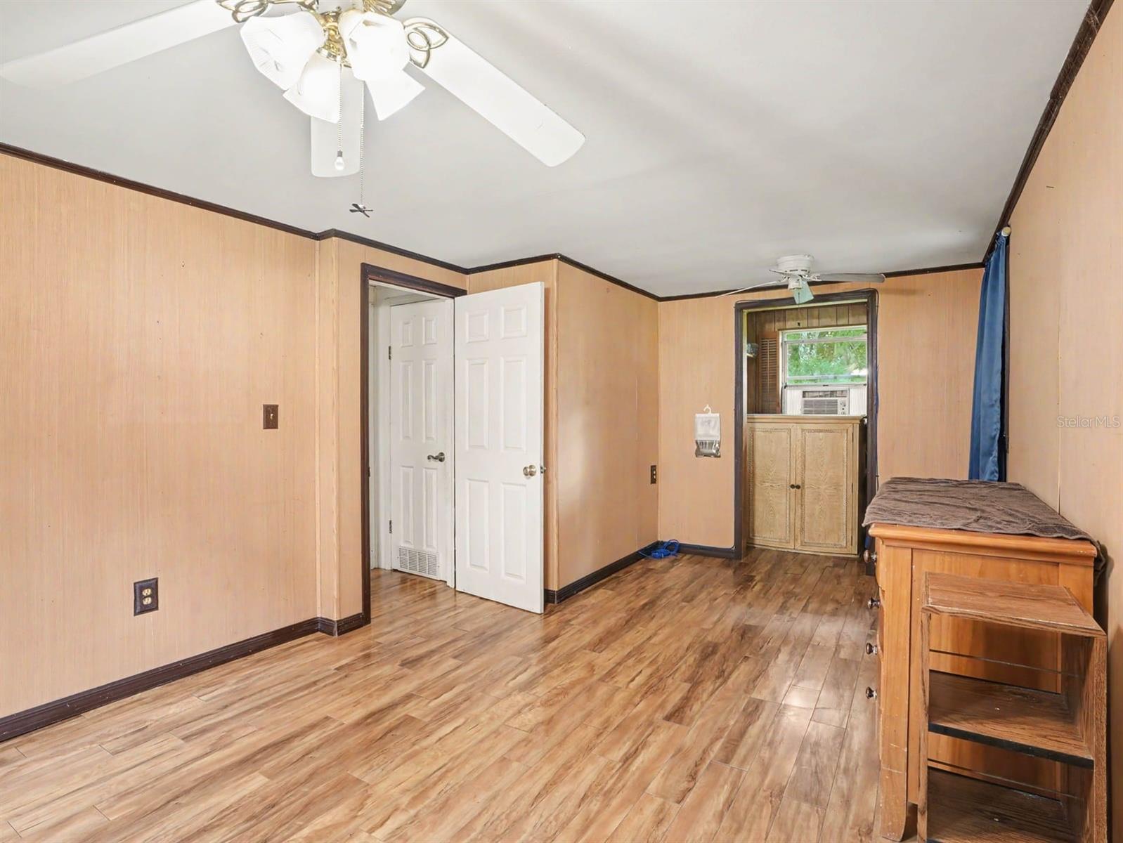 Generously Sized Bedroom with Wood Flooring, Multiple Windows & Closet Space