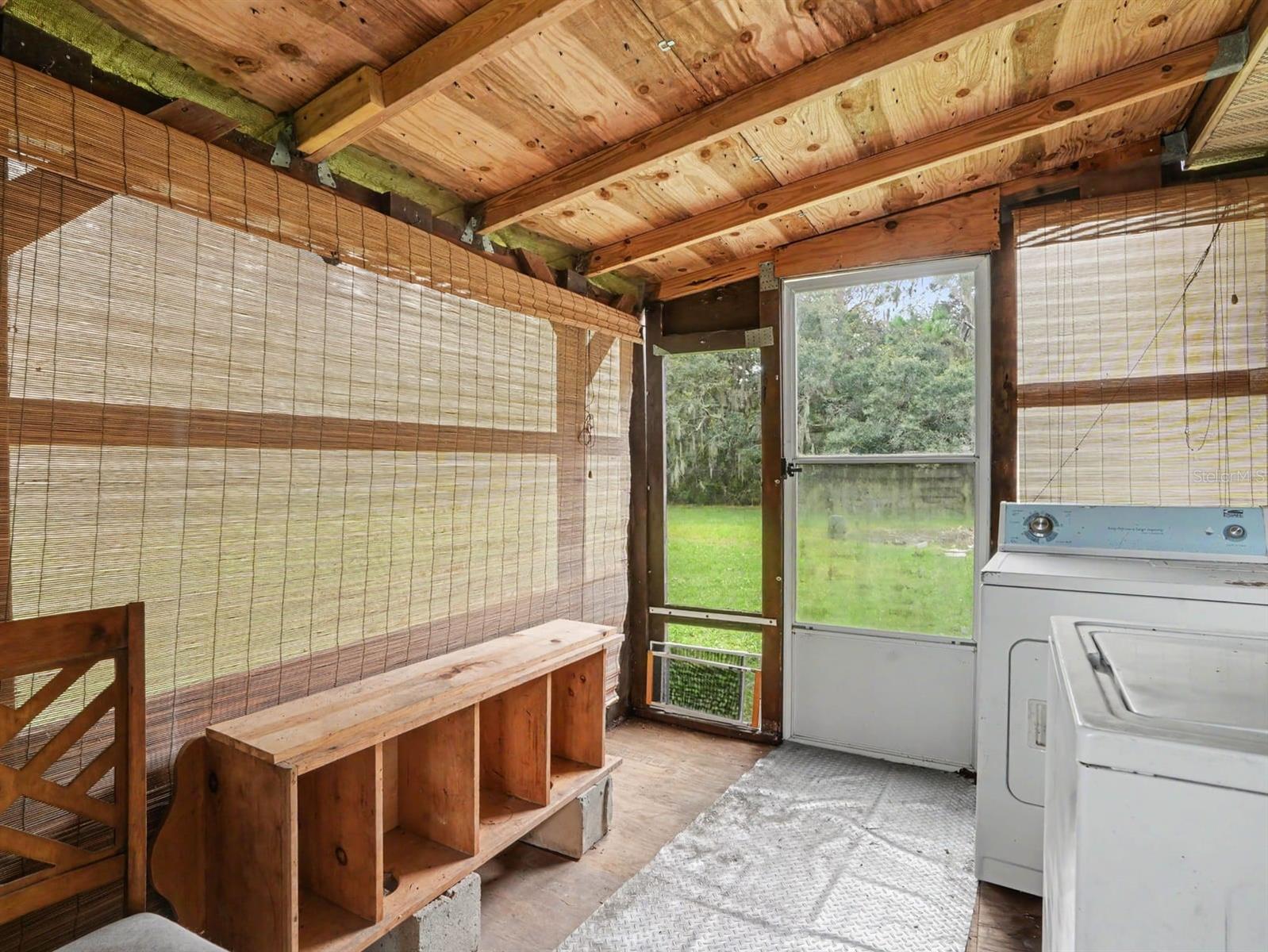 Utility Space: Washer, Dryer & Exposed Wood Beam Ceiling