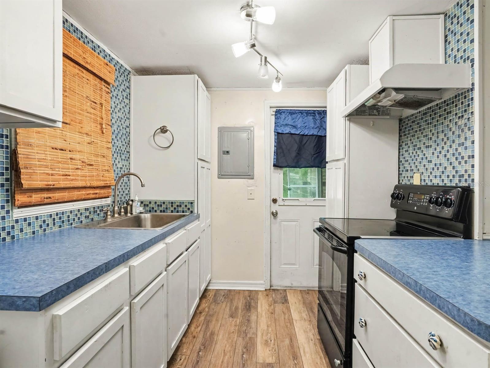 Galley Kitchen with Double Sink & Black Gas Range